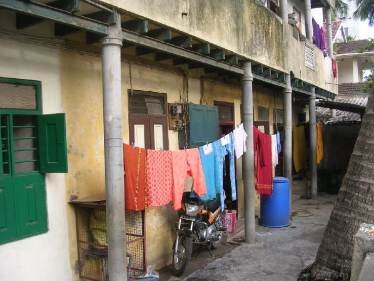 some clothes hanging on a rope outside of a building
