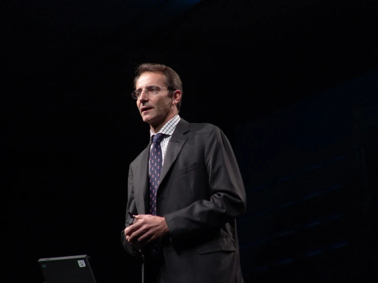 a man in business suit giving a speech