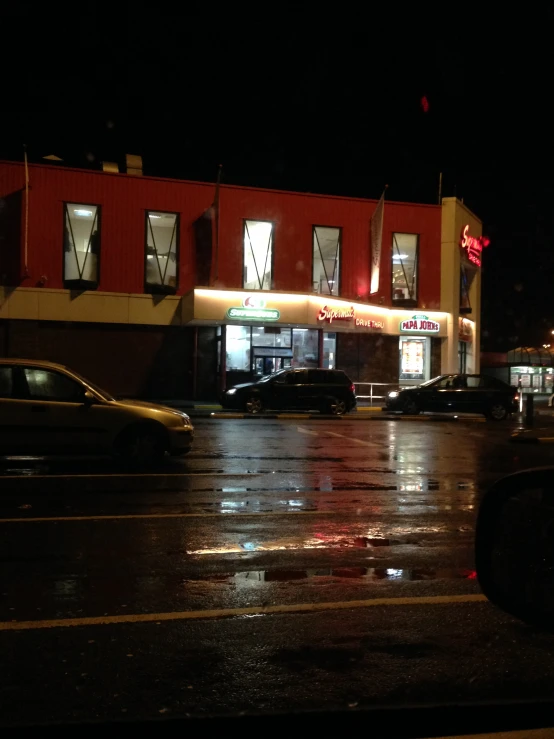 a small storefront at night in the rain