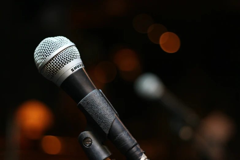 a close up of a microphone with a black background