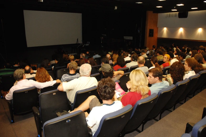audience at an event watching a movie on the screen