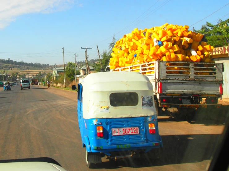 a blue and white truck with yellow packages on it