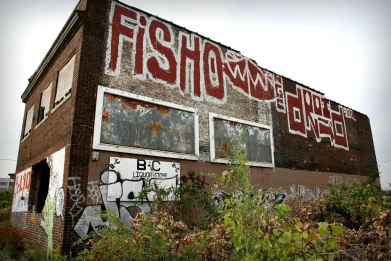 a run down building has graffiti on the side