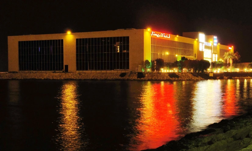 a night time view of the lights and water at a casino