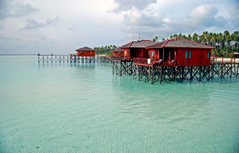 a group of wooden houses sitting on top of a body of water