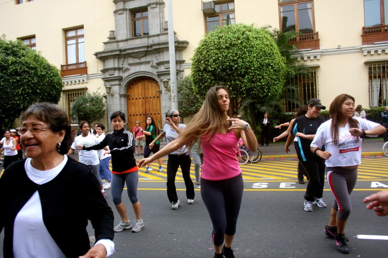 the women are running on a city street