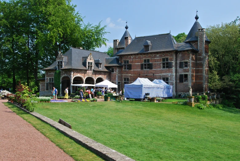 a large brick building with a garden next to it