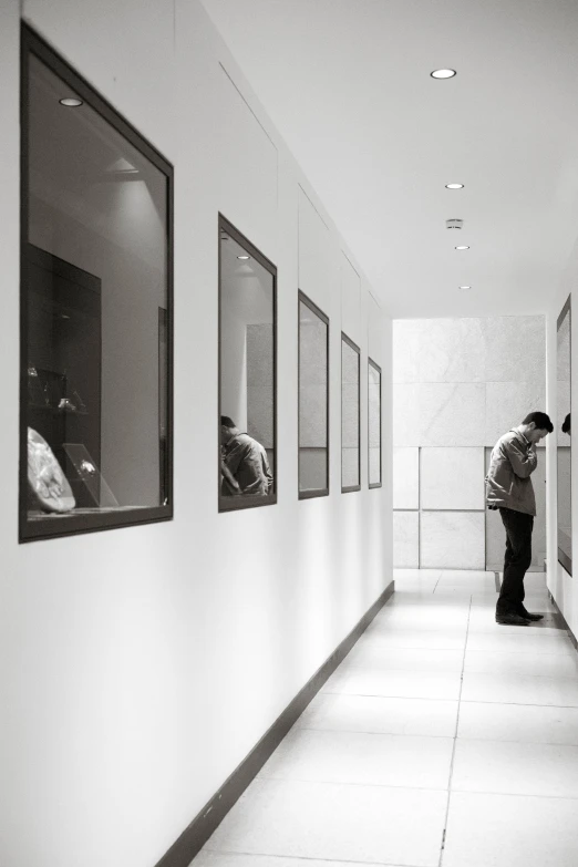 black and white po of a person standing in a hallway