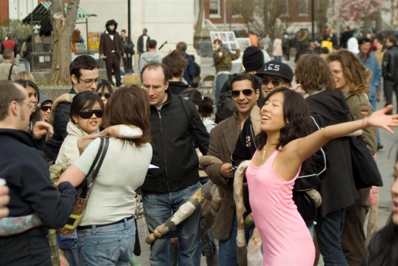 a crowd of people standing in the street