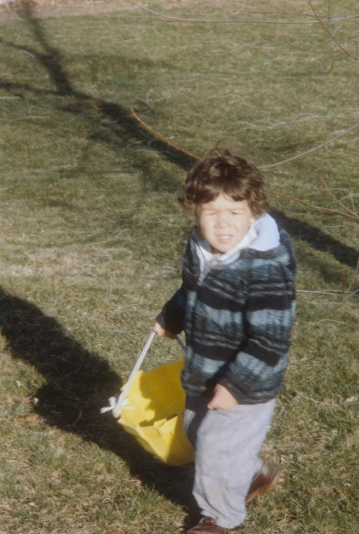 a  holding a bag of candy in the grass