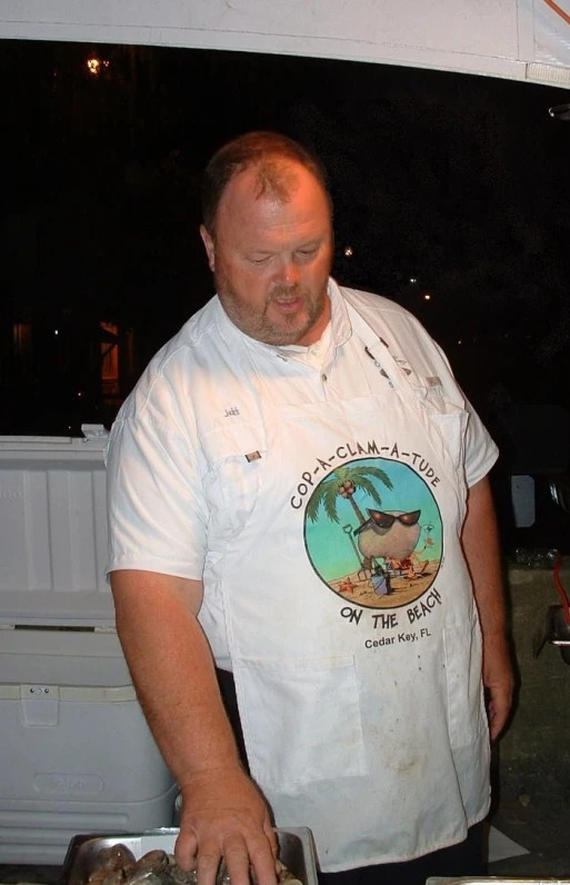 there is a man preparing food on the grill