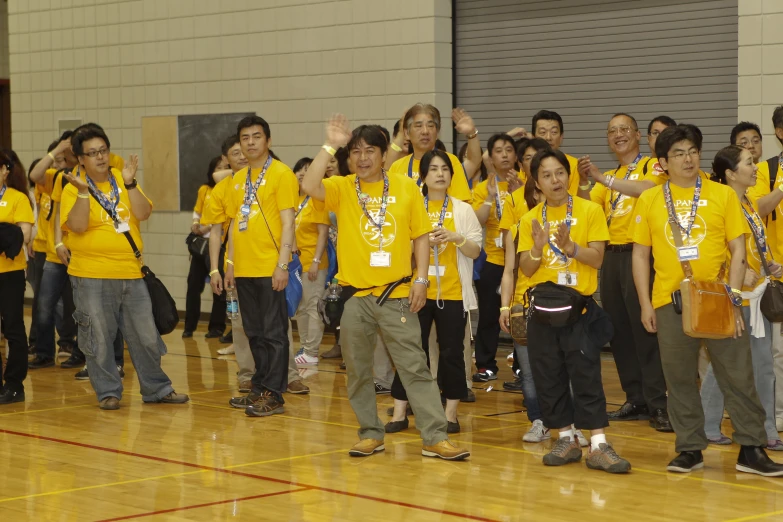 group of children in yellow shirts holding medals and posing for po