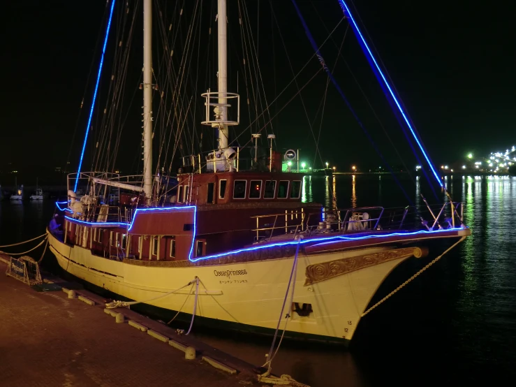 the boat has lights on it's sails and lights on it's rigs