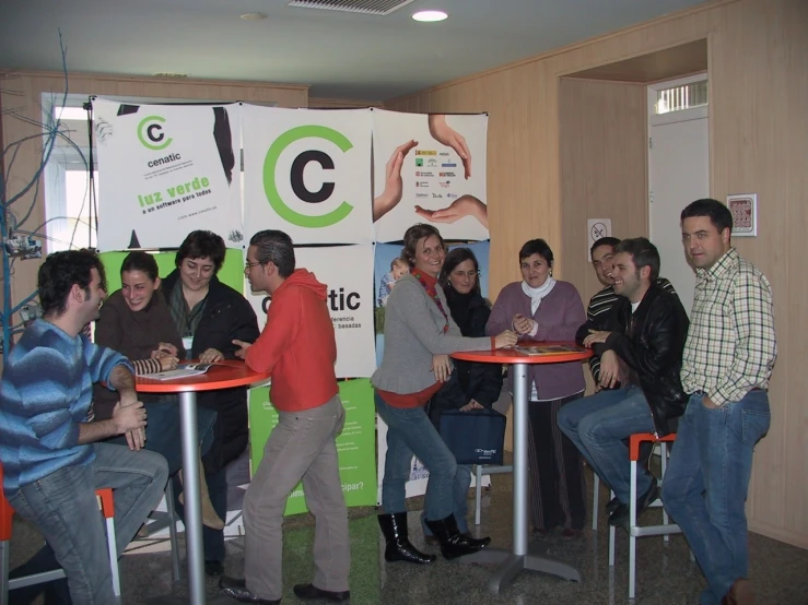 a group of young people gathered around tables and chairs