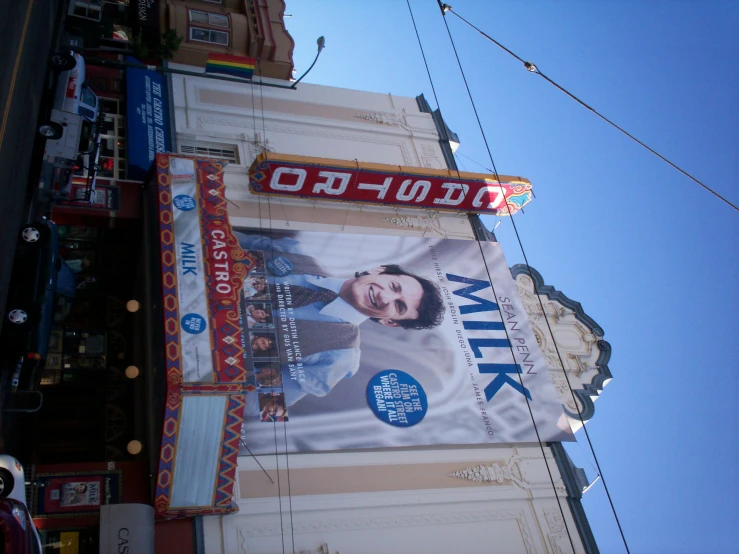 a large poster with an image of a man hanging on the side of a building