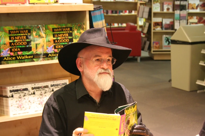 an older man in a liry is reading a book