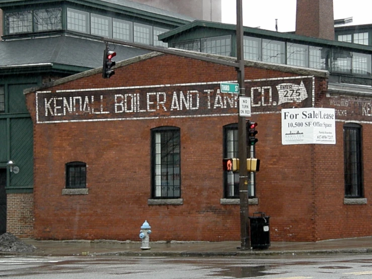 an old brick building with several signs on the side