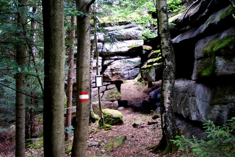 an empty trail going between two large rocks