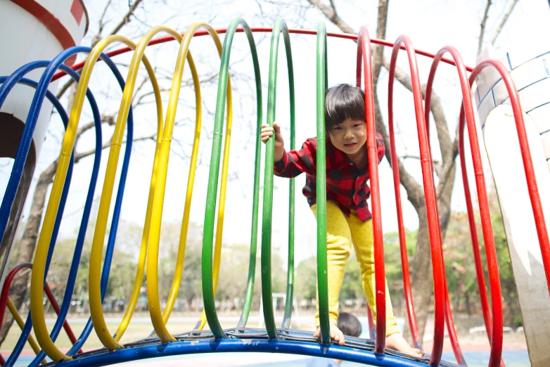 a  plays on the ropes of a playground