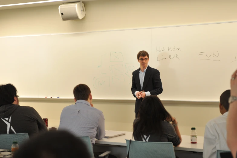 a man teaching a class at a classroom