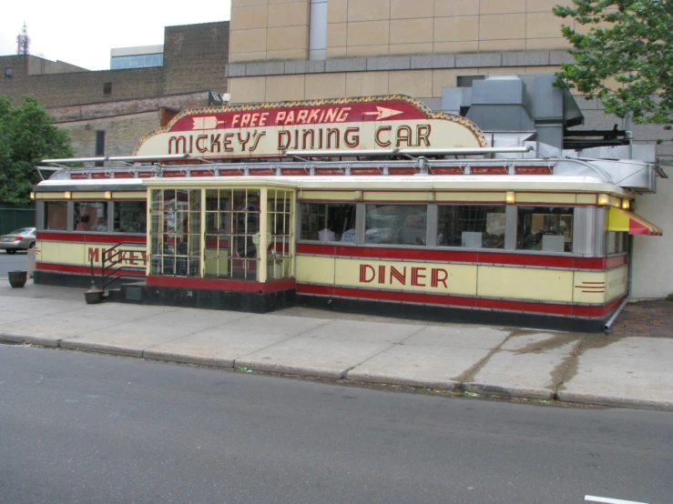 an old diner that is empty sitting by the curb
