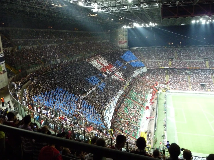 a soccer stadium full of people with blue and white flags