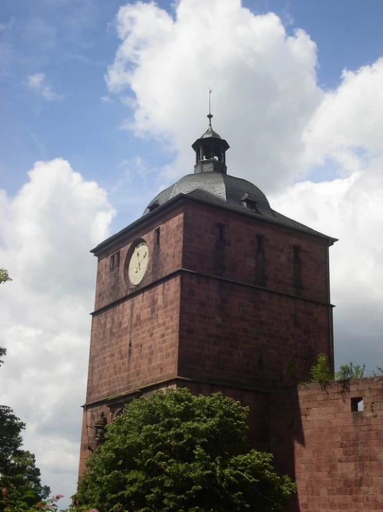 there is a clock tower and a building with trees in front