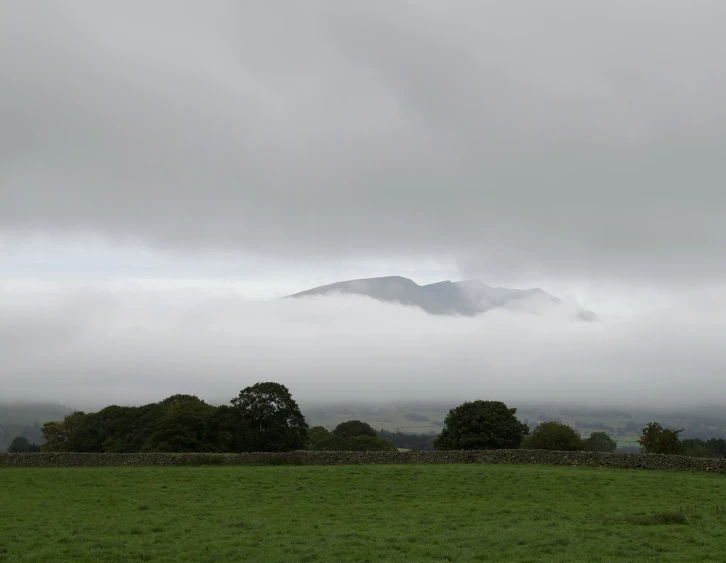 an open field with hills in the distance