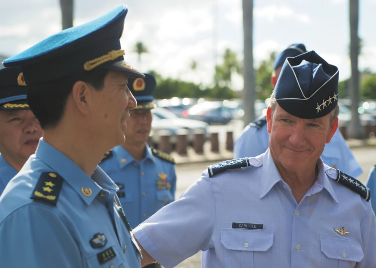 the two men are in uniform talking to each other