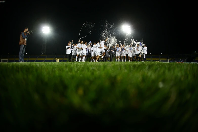 the soccer players are posing on a field with their coach