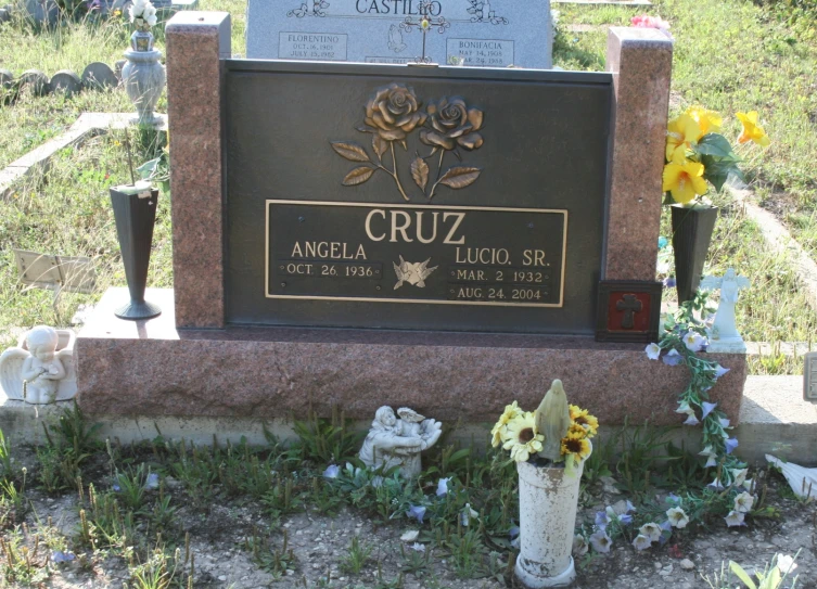 a small plaque surrounded by flowers in the grass