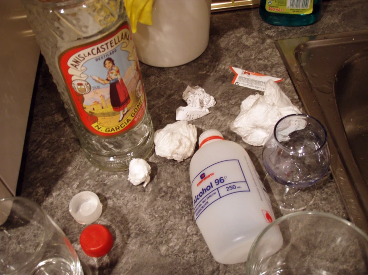 a bottle is sitting on the counter by other items