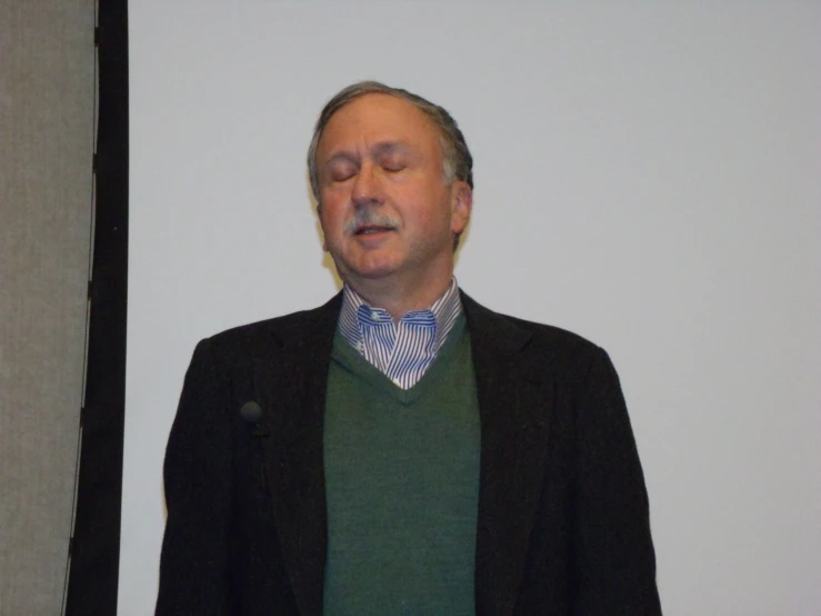 a man is standing in front of a screen