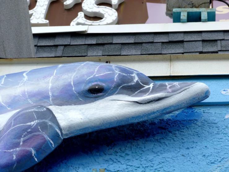 a dolphin statue that is sitting on the ground