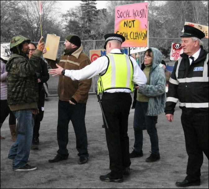 a group of men are holding wooden signs