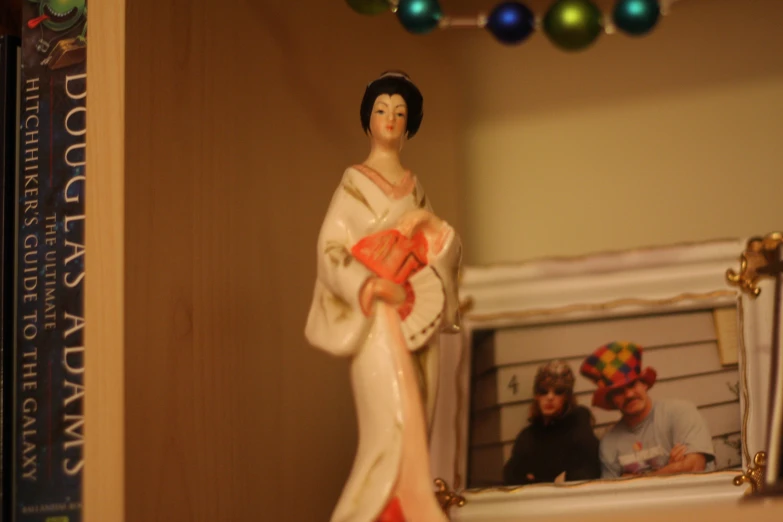 the figurine depicts a young woman wearing traditional chinese garb