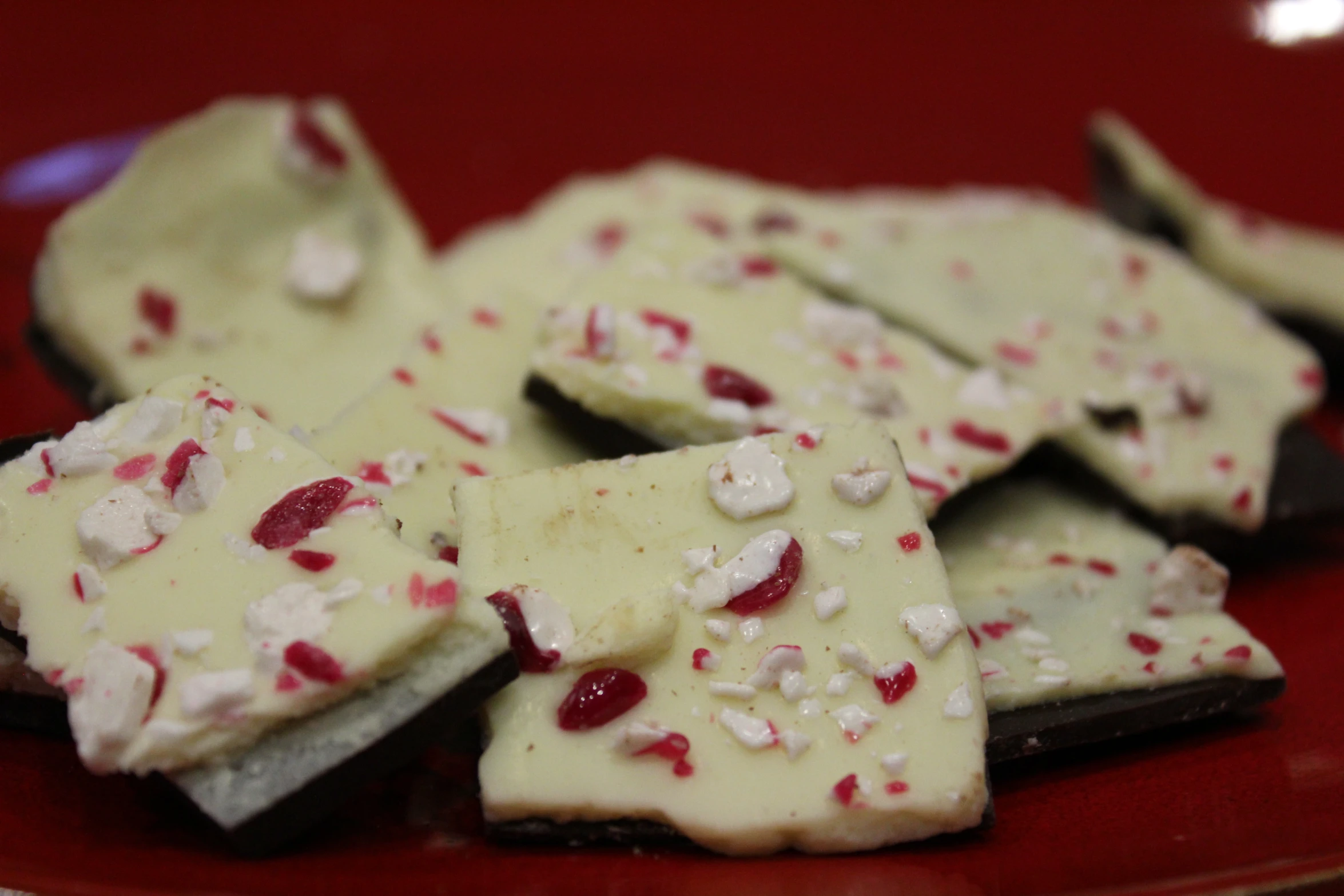 some pieces of white and red food on a plate