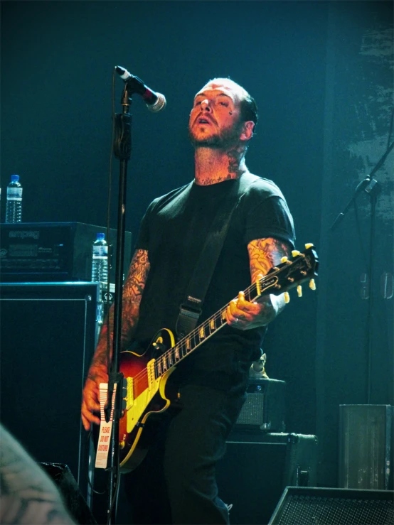 a man that is on stage with a guitar