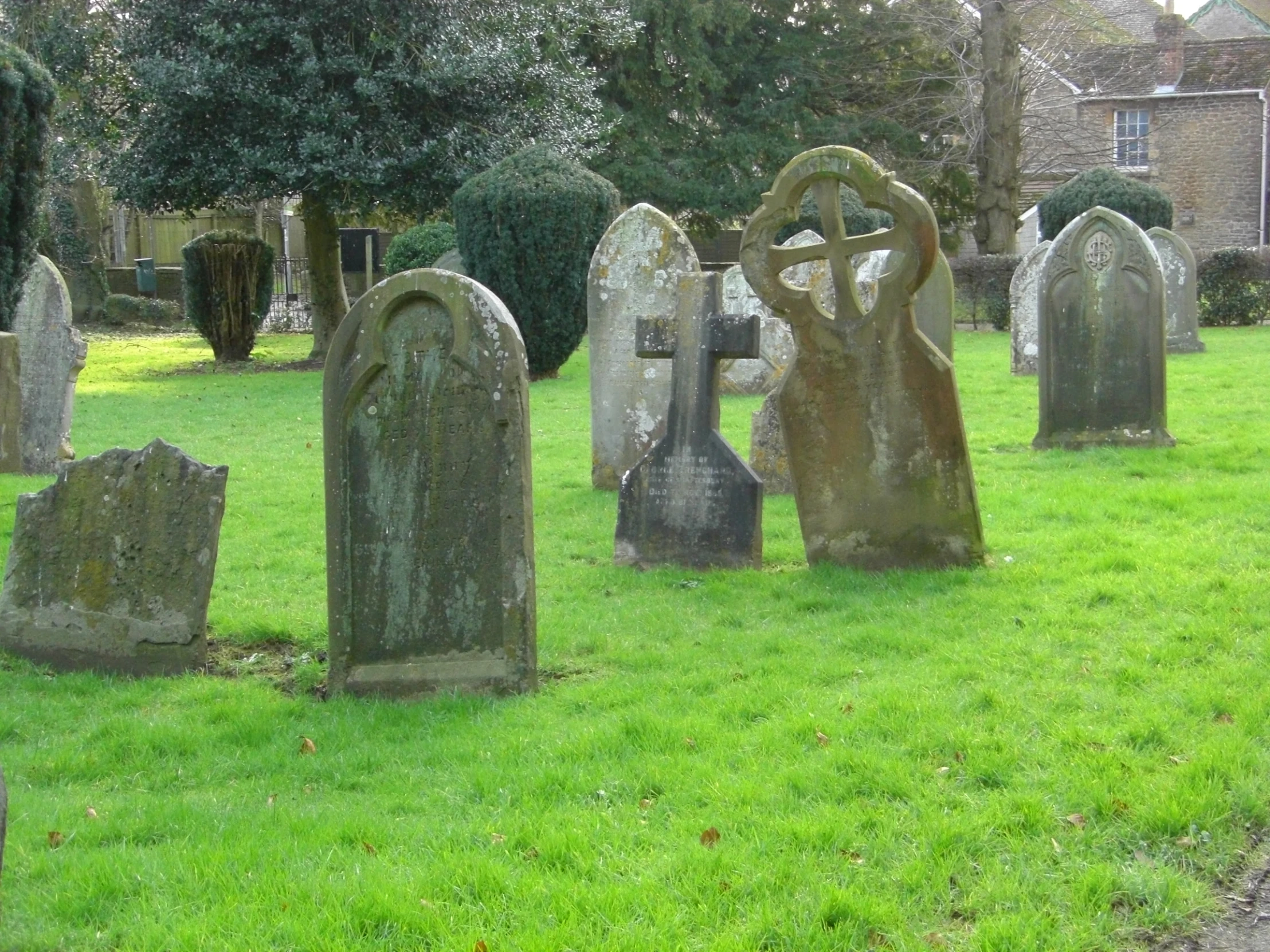 a grass lawn with old graveyards in the middle of it