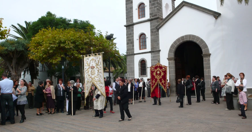 people standing in front of a white building