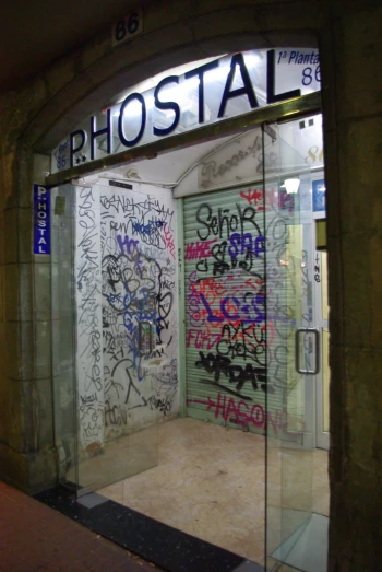 there is a glass door that has some graffiti on it