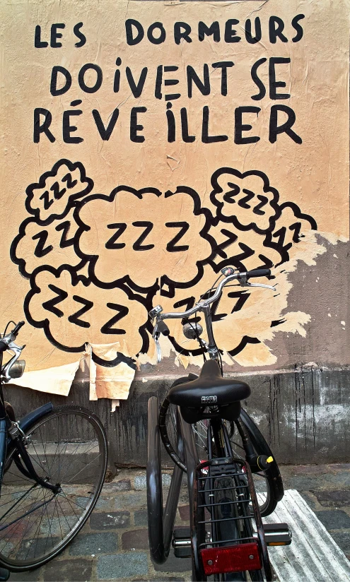 a group of bicycles are parked beside a large painting