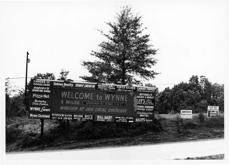 a welcome sign in the front yard to a winery