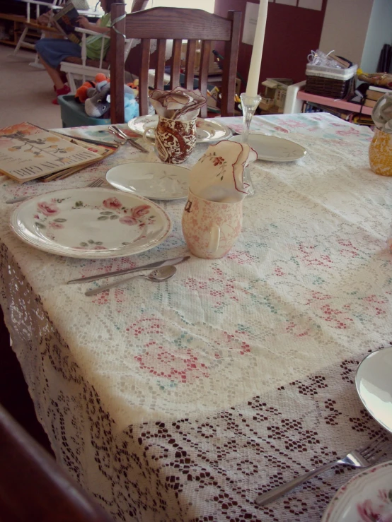 a table set for three with a plate and cup on it