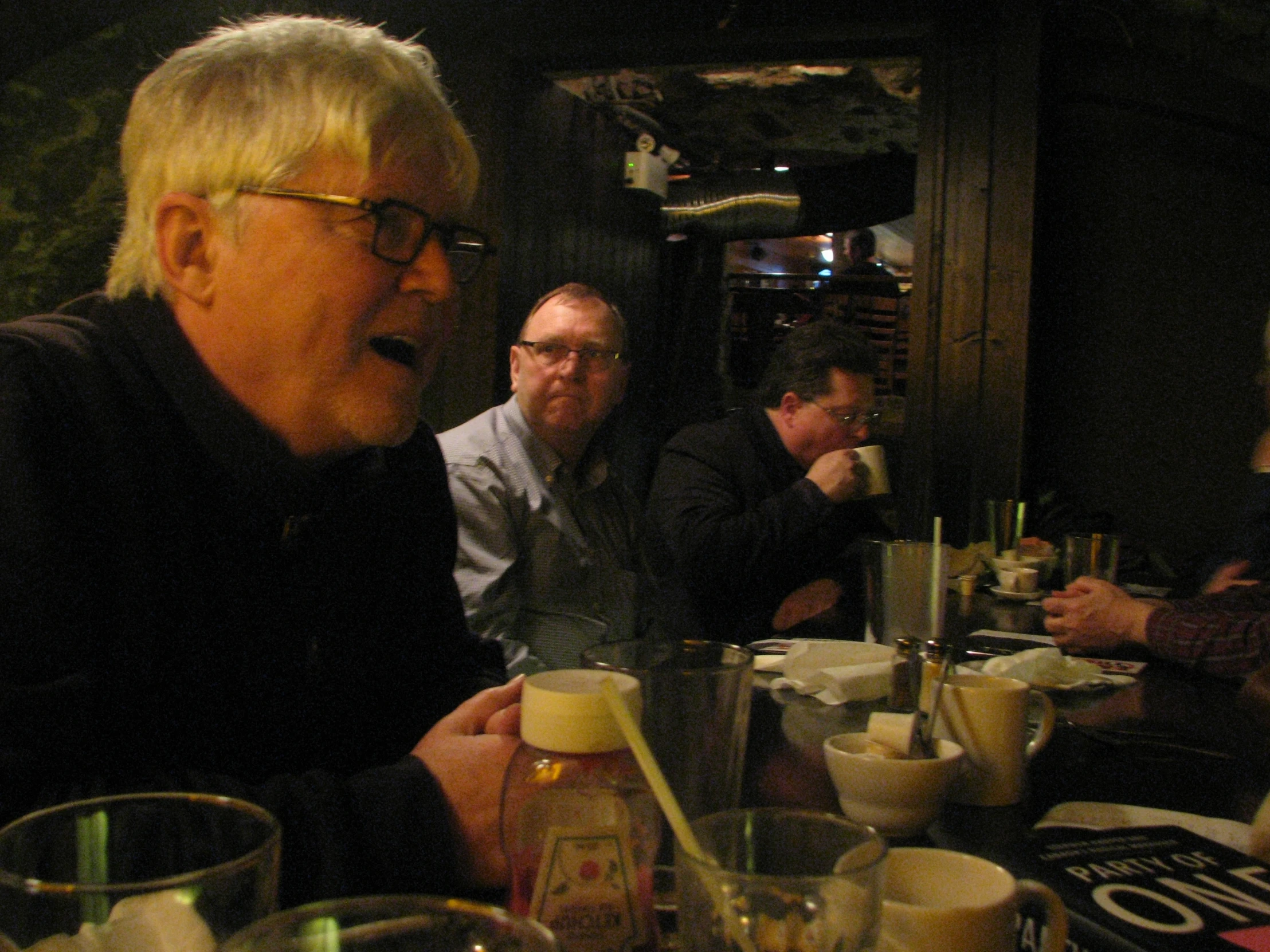 a group of people sitting at a restaurant together