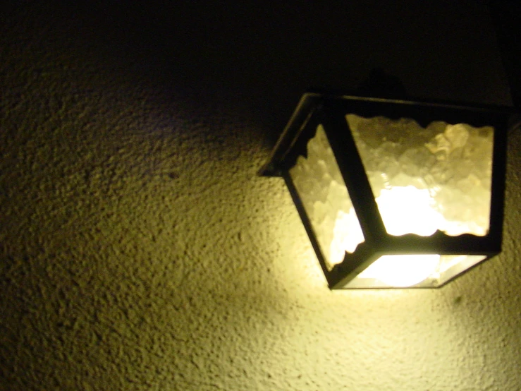 a light is lit on a wall outside