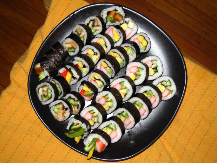 various types of sushi are displayed on a platter