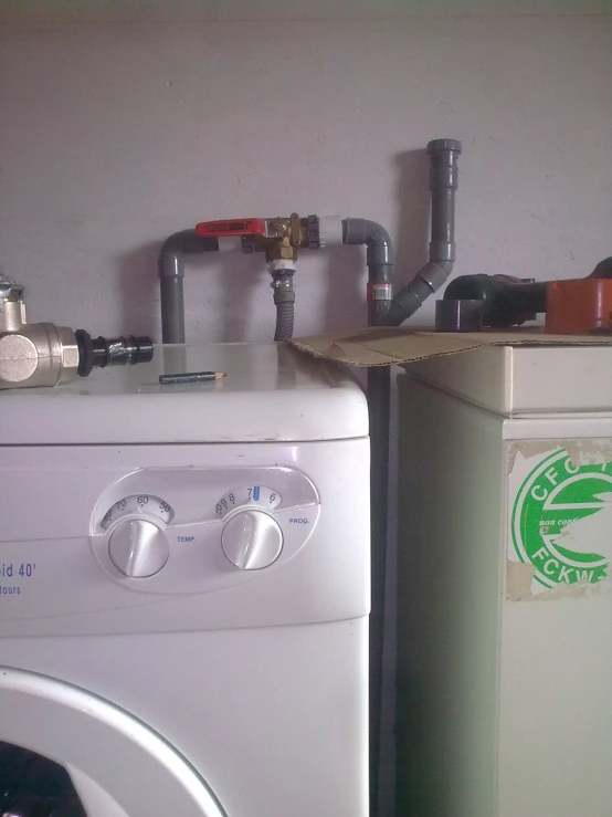 a white washer sitting next to a white stove top oven