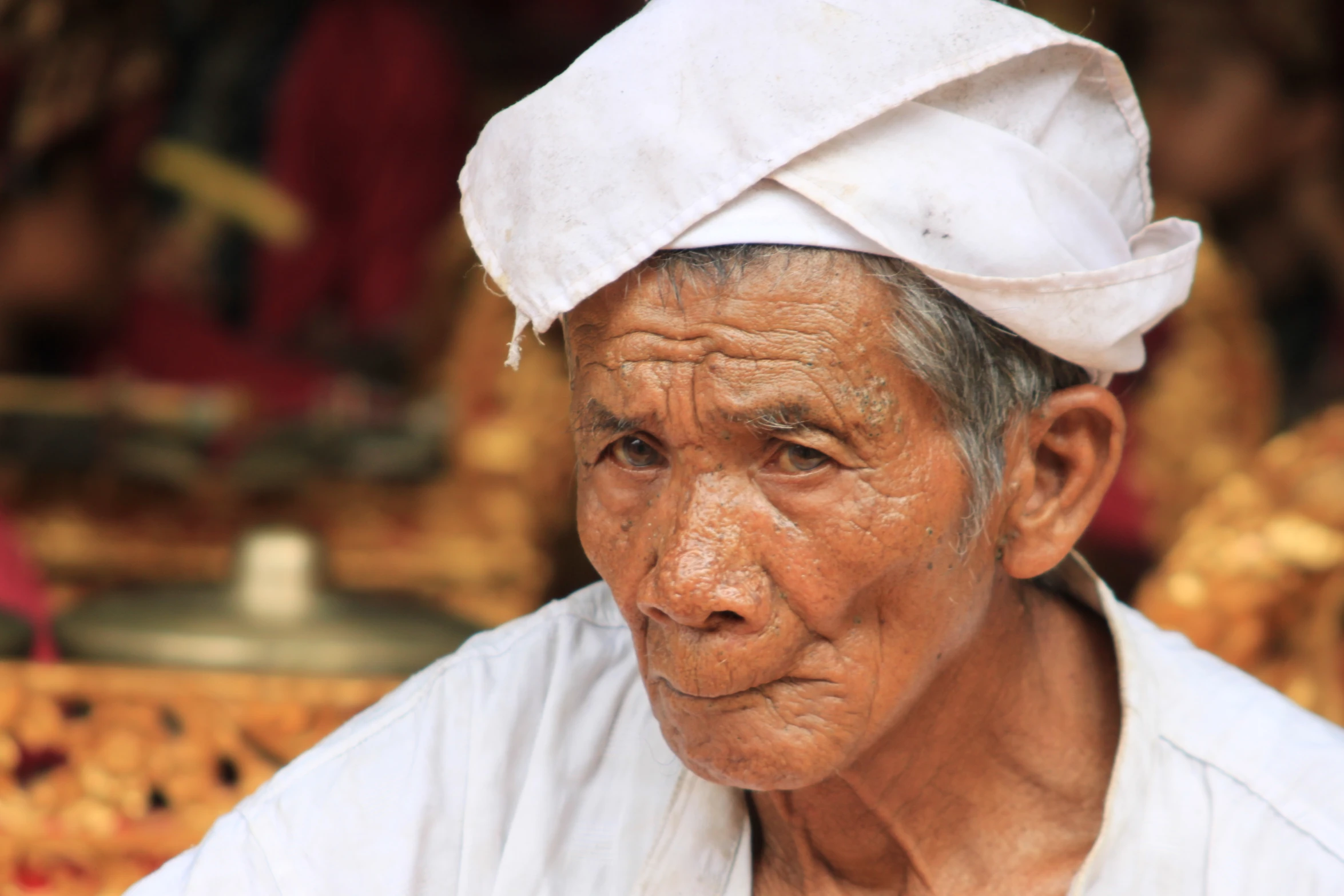 an old man with a white head band and shirt