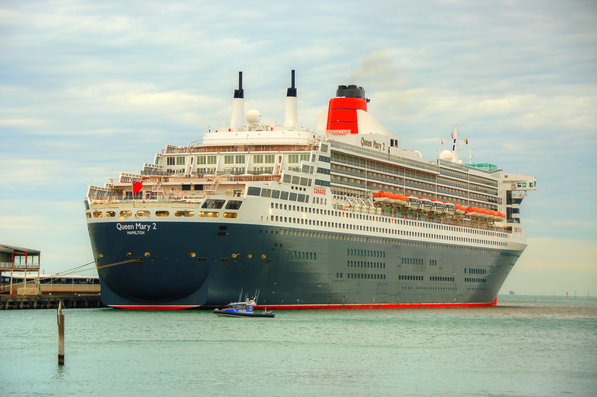 a large ship docked next to the shore